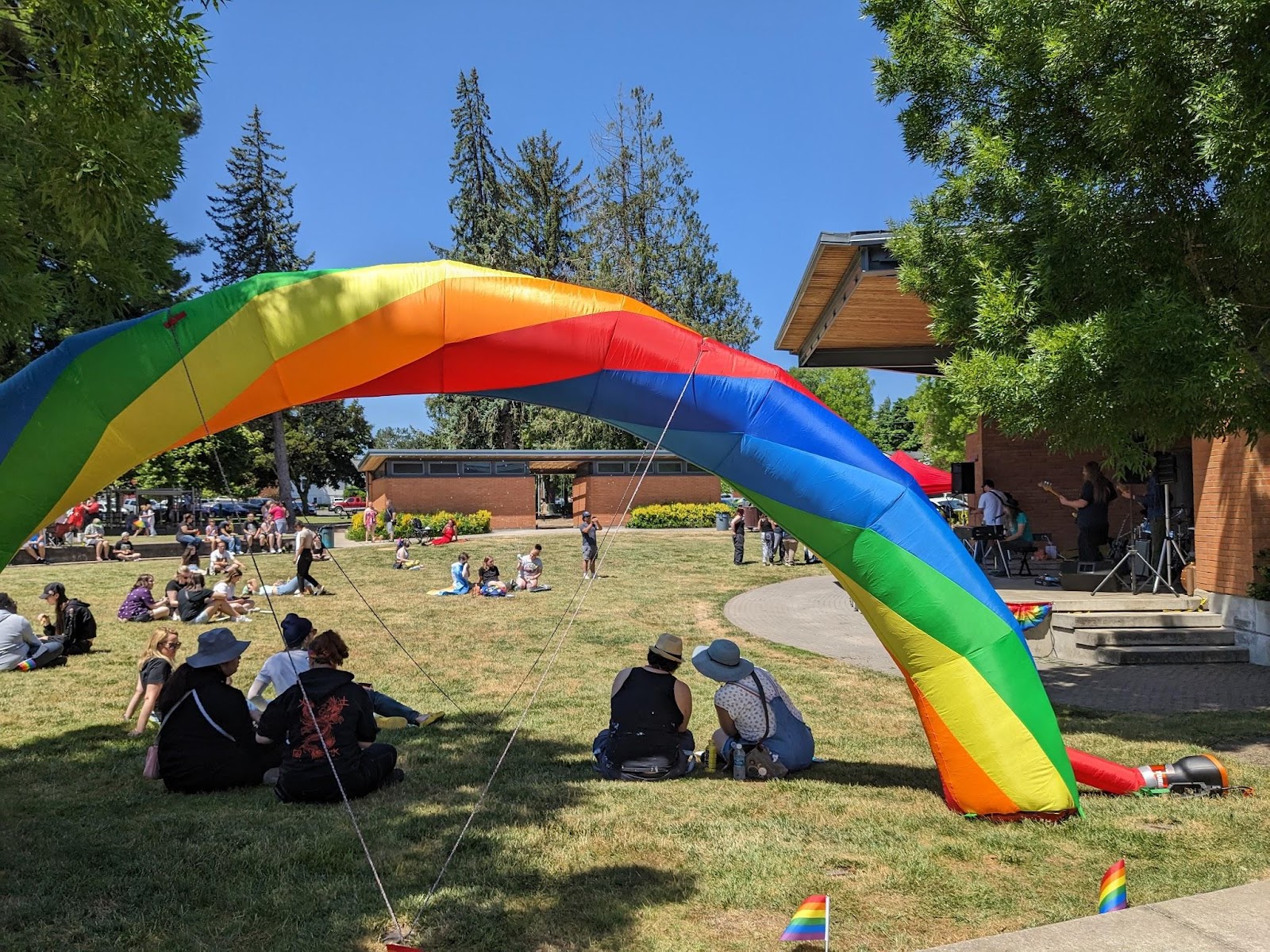 A photo of the Main Street Ampetheater Park in Monmouth with a large blow-up rainbow in front